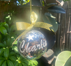 Close-up of personalized Christmas bauble with dog’s name.